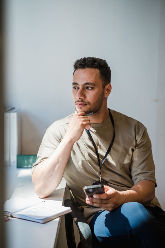 Man sitting alone at his office desk thinking, wondering why he keeps getting passed over for promotion