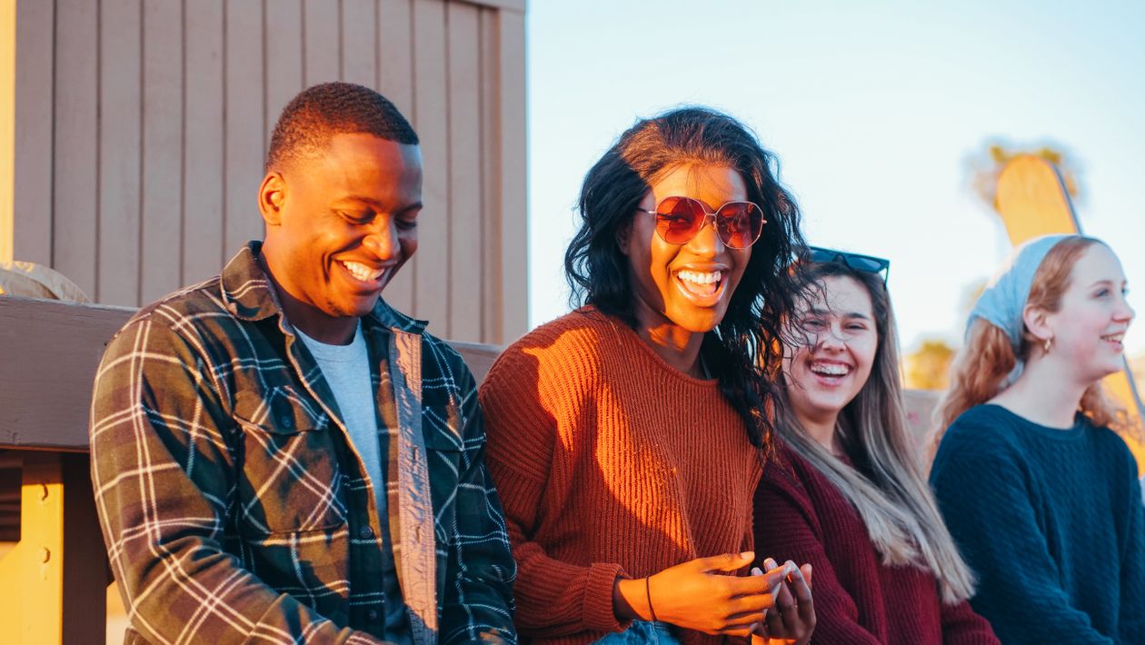 Group of friends sitting together relaxed and enjoying time, comfortable in social setting