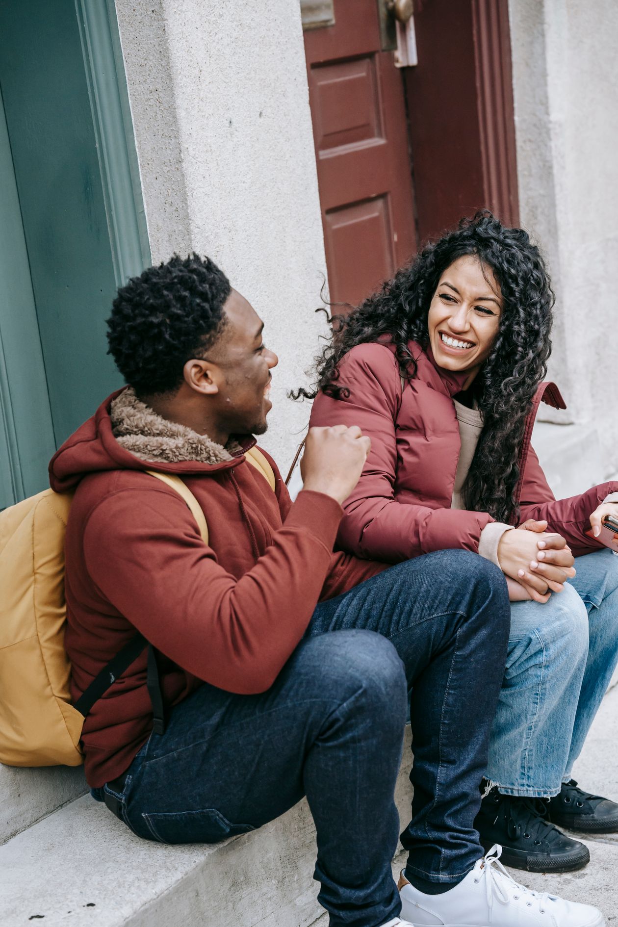 How Bad Breath Destroys Your Confidence (And How to Get It Back) 1 Young happy multiracial friends talking and laughing together on stairs, confident and close