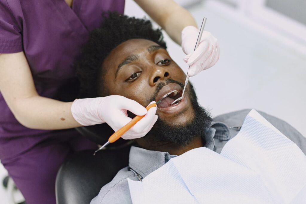 Man in the chair at a dentist appointment for a checkup, related to preventing cavities and tooth decay