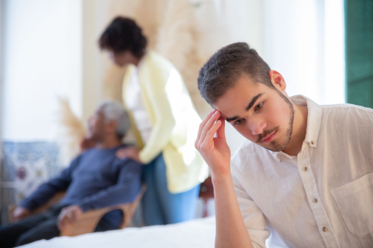 Man with hand on head looking distressed and overwhelmed by emotional burden and self-doubt