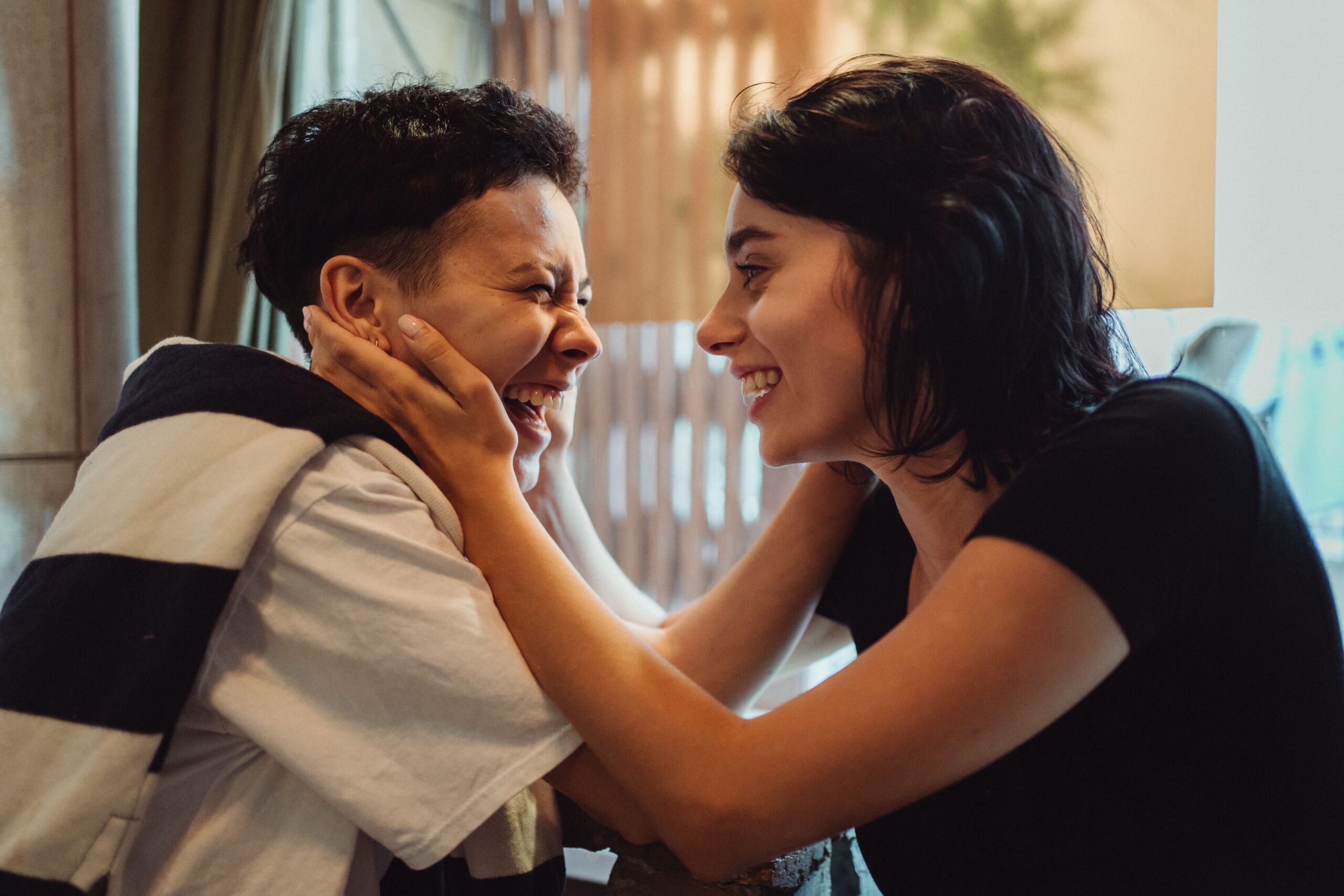 Oral Probiotics for Tonsil Stones: The Surprising Bacterial Solution 1 Two people smiling close together, showing the confidence that comes when tonsil stones and bad breath are gone