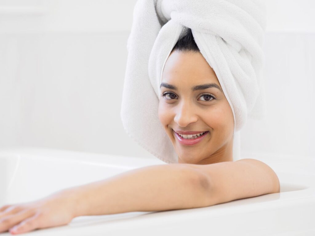 Relaxed woman with a towel turban during her self-care and oral care routine