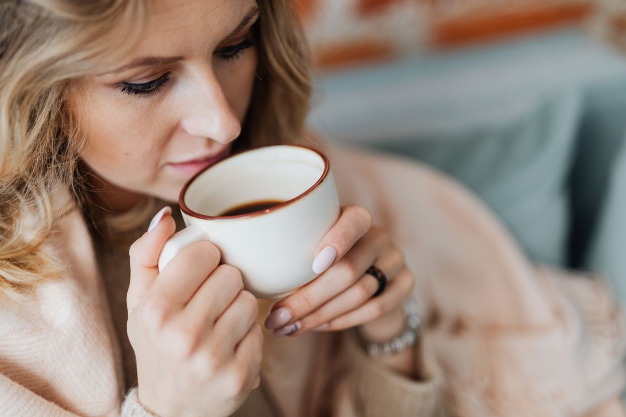 Why Does Coffee Give You Bad Breath? 1 Woman drinking coffee, the everyday habit that dries out your mouth and causes coffee breath