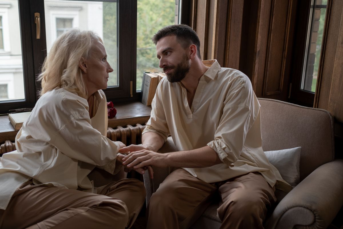 How to Tell Someone They Have Bad Breath Without Hurting Them 1 Couple sitting together holding hands after a difficult but loving conversation about bad breath