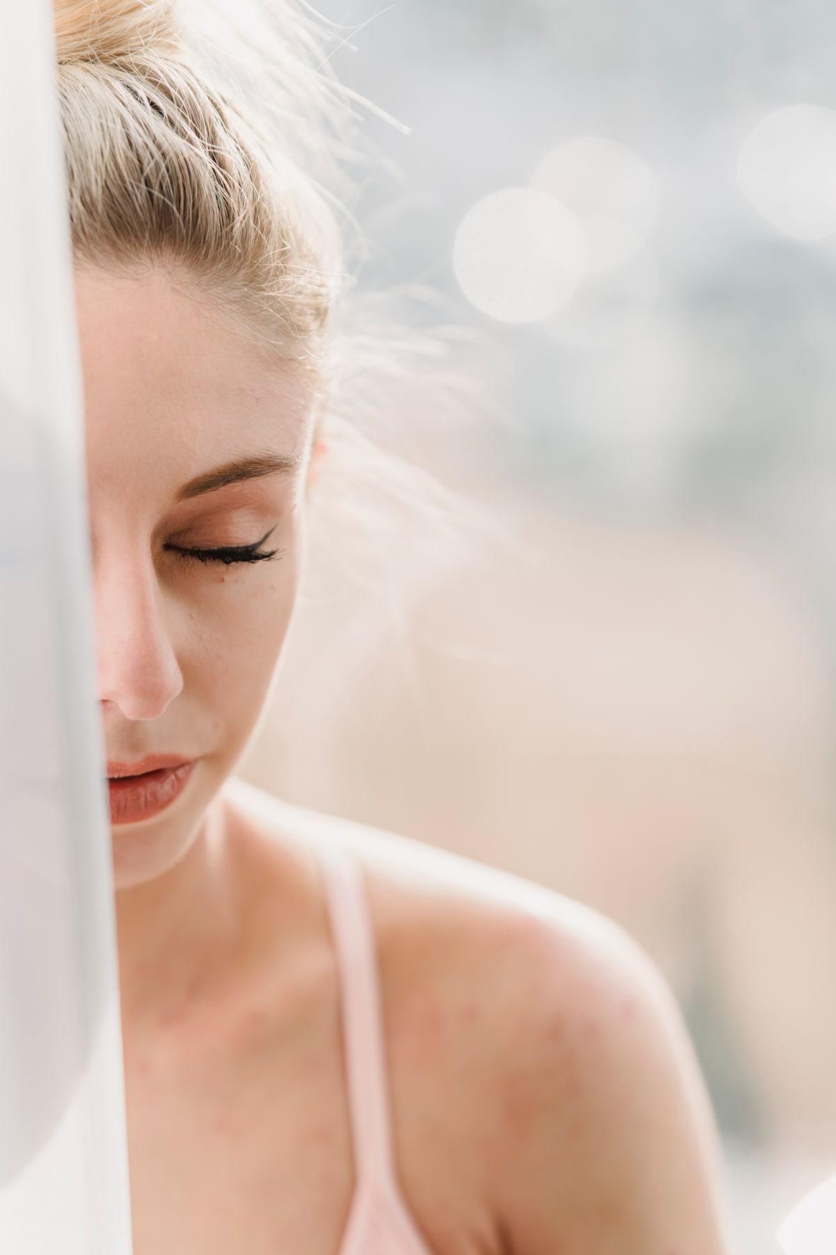 Person sitting calmly in morning light after the embarrassment of bad breath has passed and a plan is in place