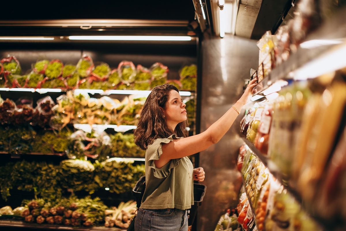 What to Buy for Bad Breath: A Cost Comparison of All 5 Options 1 Woman comparing products on a shop shelf, deciding what to buy for bad breath