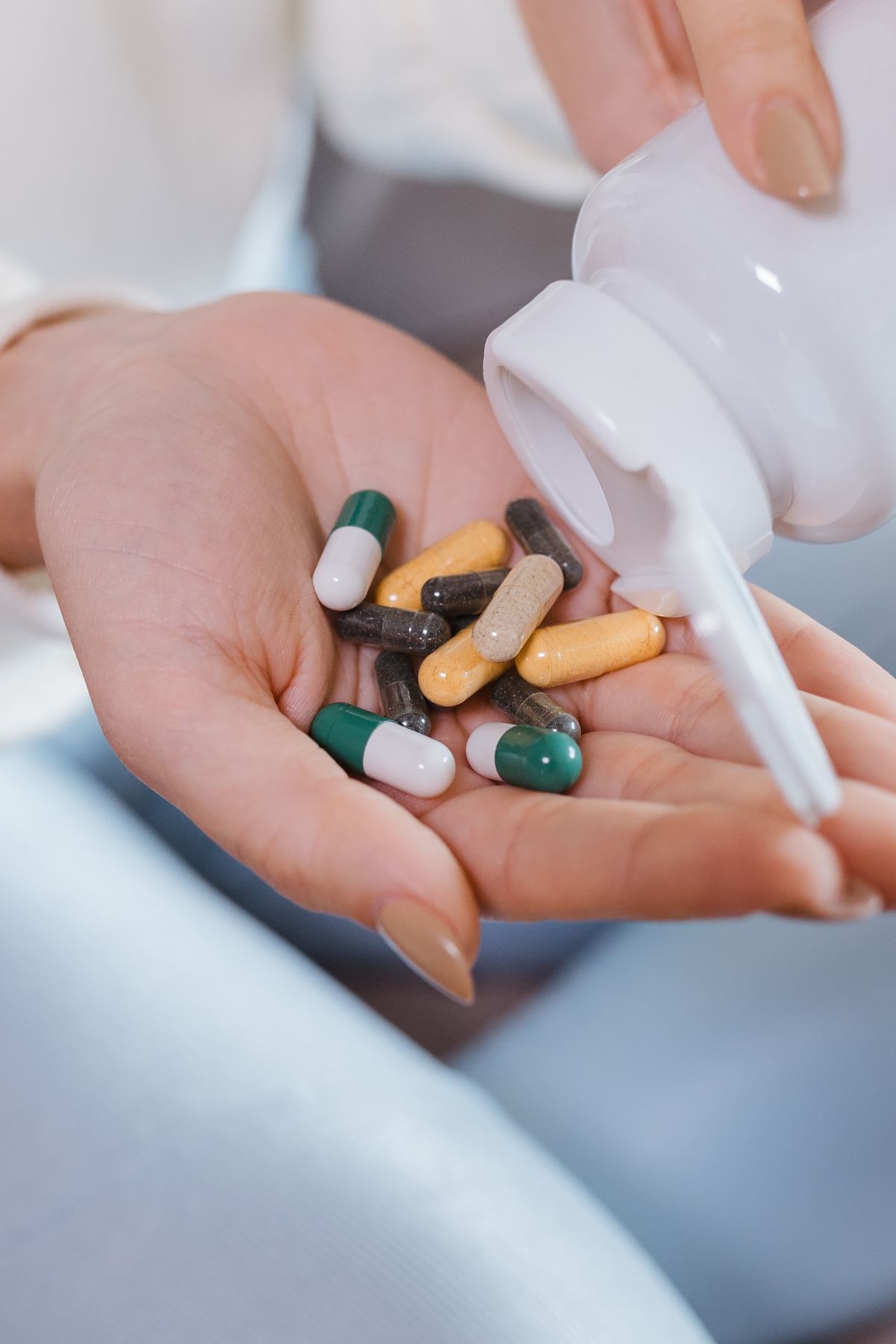 Gut Probiotics vs Oral Probiotics: Why the Wrong One Does Nothing 1 Hand holding supplement capsules, illustrating the difference between gut probiotics and oral probiotics
