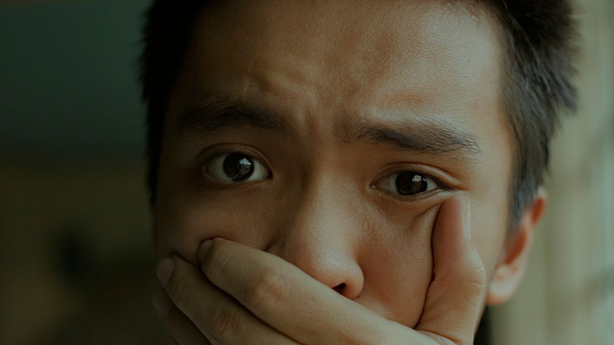Why Garlic Breath Won't Go Away — And What Finally Does 1 Young man covering his mouth, worried about lingering garlic and onion breath