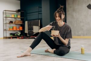 Woman eating a healthy low-carb meal, a common trigger for keto breath and fasting breath