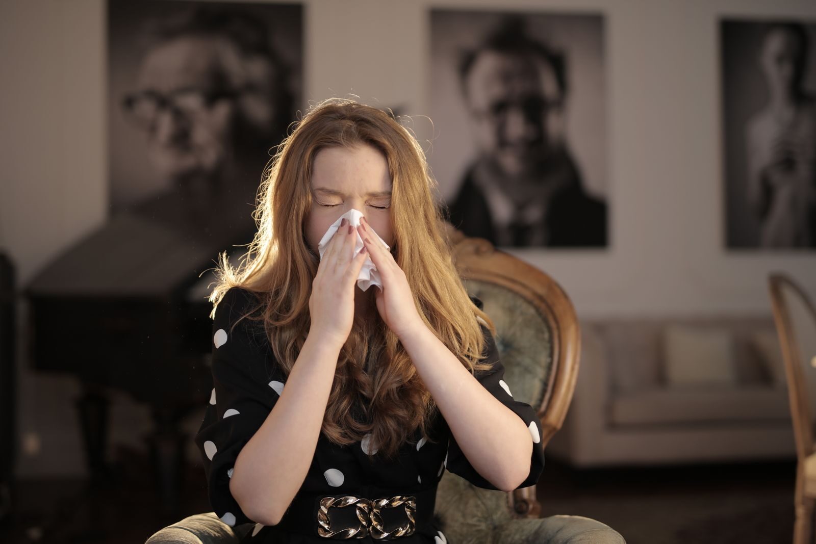 Bad Breath After Being Sick? Why It Lingers After a Cold or Flu 2 Woman wiping her nose with a tissue while recovering from a cold, a common trigger for bad breath after being sick