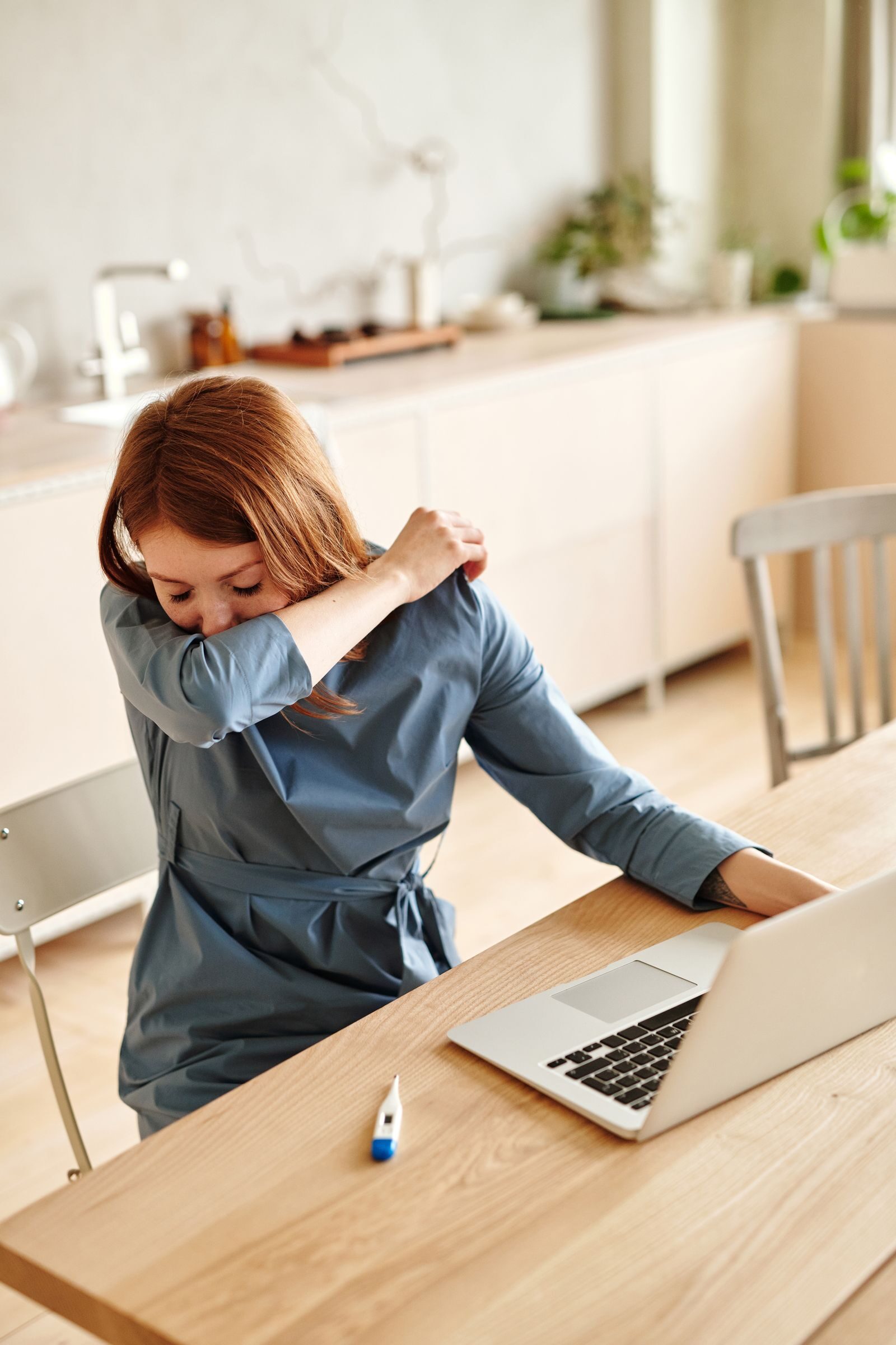 Bad Breath After Being Sick? Why It Lingers After a Cold or Flu 1 Woman covering her mouth while sick, worried her breath smells after a cold or flu